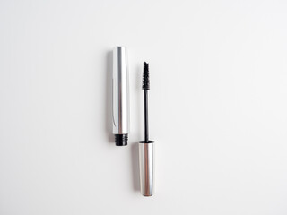 Fototapeta premium Open mascara isolated on a white background. Cosmetics for women. Brush for applying mascara. Top view, flat lay