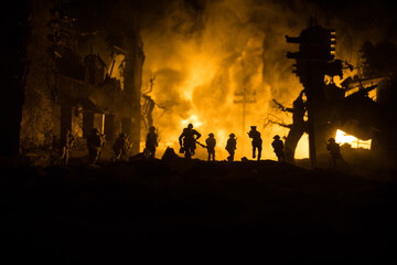 War Concept. Military silhouettes fighting scene on war fog sky background, World War Soldiers Silhouette Below Cloudy Skyline At night. Battle in ruined city. Selective focus