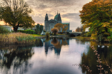 Beautiful sunrise scenery of Galway cathedral reflected in the Corrib River in Ireland 