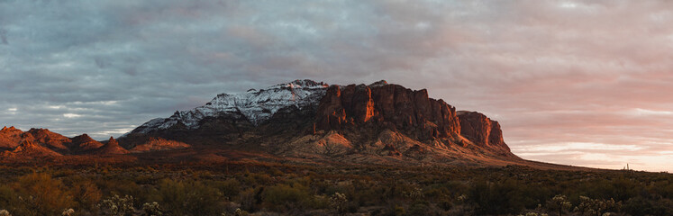 Superstition Mountain in Phoenix, Arizona panorama during sunset in winter with snow