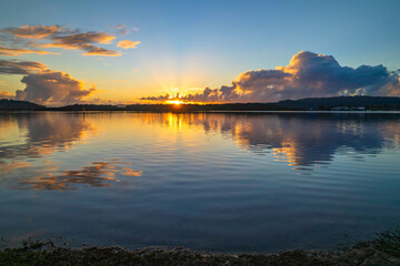 Aerial sunrise over the bay with clouds and reflections
