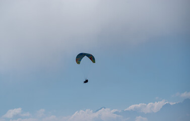 Beautiful image of a paraglider flying high up in the sky - Powered by Adobe