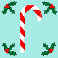 Traditional christmas candy, candy cane on blue background and mistletoe leaves