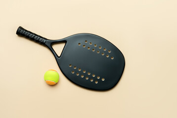 Black professional beach tennis racket and ball on beige background. Horizontal sport theme poster,...
