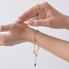 Hands close-up with jewelry on white background