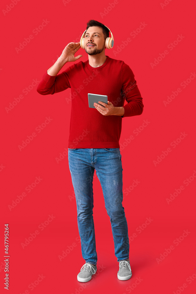 Poster man with tablet computer and headphones on color background