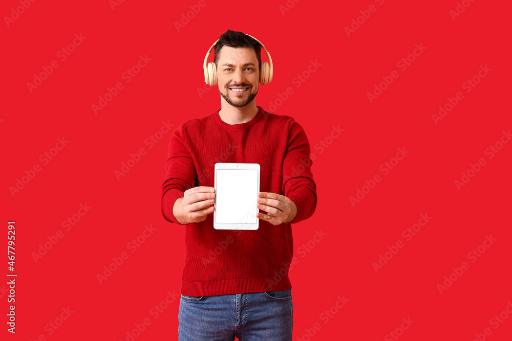 Poster man with tablet computer and headphones on color background
