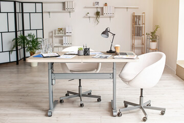 Interior of modern light office with table and chairs