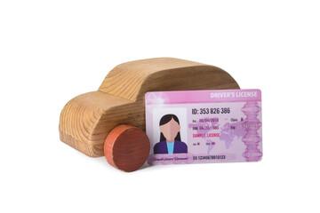 Wooden car with driving license on white background