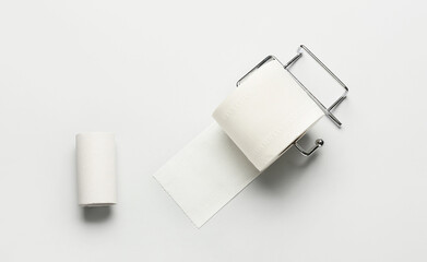 Holder with toilet paper roll and cardboard tube on white background