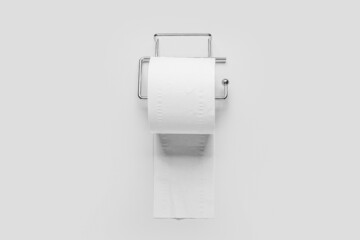 Holder with toilet paper roll on white background