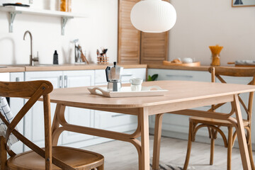 Stylish kitchen interior with wooden dining table