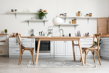 Stylish kitchen interior with wooden dining table