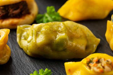Dim Sum dumplings and Bao buns on rustic stone board. Traditional Chinese food