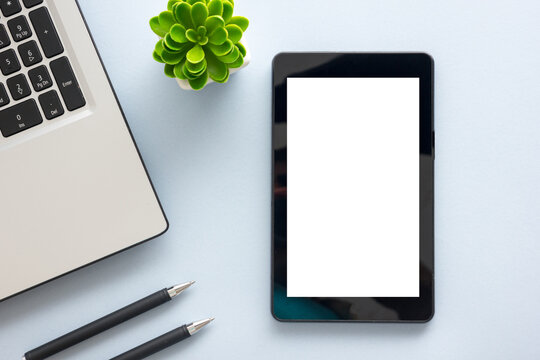 White desk office with laptop, smartphone and other work supplies with cup of coffee. Top view with copy space for input the text. Designer workspace on desk table essential elements on flat lay
