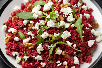 Bulgur salad with beetroot, walnuts, arugula and feta cheese. Healthy diet food