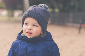 Portrait of a caucasian little boy with a curious facial expression