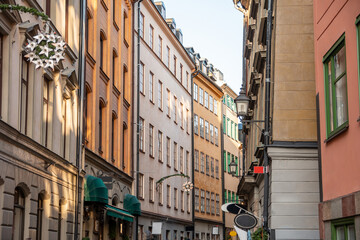 Narrow streets with New Year's, Christmas decorations, festive garlands and stars on the facades of old houses on the streets in Gamla Stan, Stockholm, Sweden, January 2020