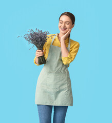 Female gardener with lavender on color background