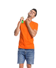 Young man with mosquito repellent on white background