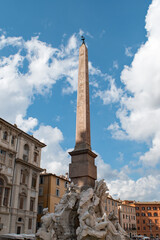 An obelisk with statuary beneath it, in piazza navona, Rome.