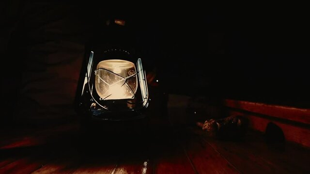 Oil Lantern Flickers on Deck of Schooner - dark and dramatic