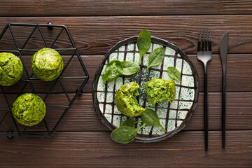 Composition with tasty spinach muffins on wooden background