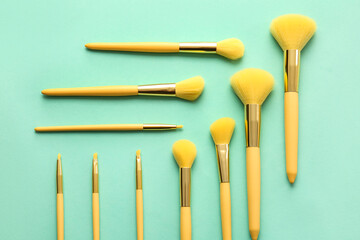 Set of beautiful makeup brushes on color background