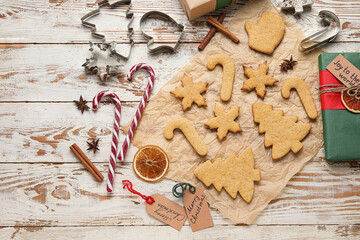 Composition with Christmas gingerbread cookies and spices on light wooden background