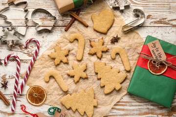 Composition with Christmas gingerbread cookies and spices on light wooden background