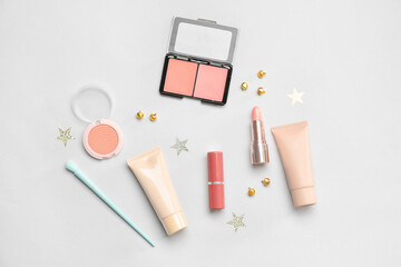 Fototapeta na wymiar Christmas composition with makeup cosmetics on light background