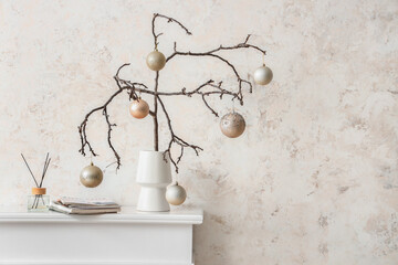 Christmas decoration with branches and balls on wall background