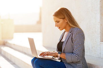 Focused woman browsing netbook during remote work