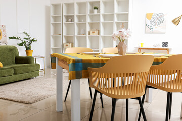 Interior of modern dining room with table, chairs and shelving unit