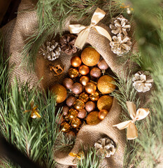 Cones and Christmas balls. Christmas decor in gold color. Christmas tree