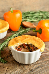 Tasty vegetable pot pie on wooden background
