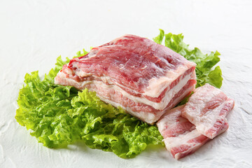 Uncooked bacon on white background