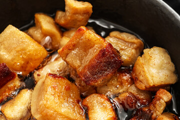 Tasty cracklings in frying pan