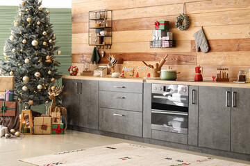 Modern kitchen with Christmas tree, decor and grey counters