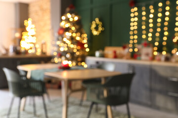 Blurred view of dining table in kitchen decorated for Christmas
