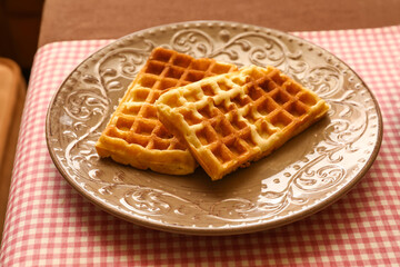 Plate of tasty Belgian Waffles on table in cafe