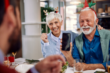 an elderly couple sharing stories over Christmas dinner