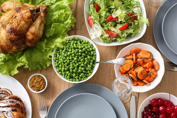 Thanksgiving table setting with roasted turkey and different food, top view