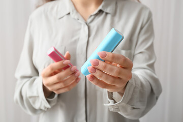 Young woman with power banks in room