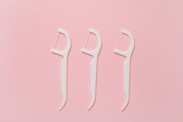 Floss toothpicks on color background