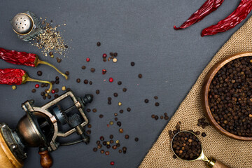Black pepper and vintage mill top view.