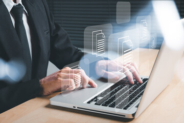 Businessman hand using laptop computer with document management icon, Document management data...