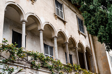Fototapeta na wymiar Terrace with ivy-covered arches. Villa Monastero, Italy