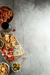 traditional Spanish or Italian tapas. jamon iberico, blue cheese, crackers, olives, grapes and dry...