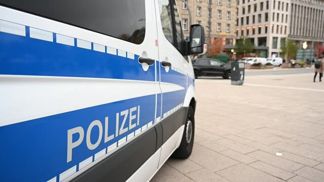 German police cars on the street. Side view of a police car with the lettering "Polizei".  Police patrol car parked on the street in Germany.